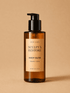 HerYang Sculpt x Restore™ Body Glow Body Oil in a clear glass bottle with a pump dispenser, showcasing a golden-colored oil.