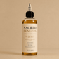 HerYang Sacred Lengths™ Ayurvedic Hair Oil in a glass bottle with a dropper for nourishing hair treatment.