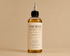 HerYang Sacred Lengths™ Ayurvedic Hair Oil in a glass bottle with a dropper for nourishing hair treatment.