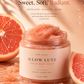 Her•Yang Glow Luxe Sugar Body Scrub in a jar with a textured sugar scrub surface and a luxurious gold lid.