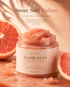 Her•Yang Glow Luxe Sugar Body Scrub in a jar with a textured sugar scrub surface and a luxurious gold lid.