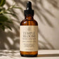 Her•Yang Temple Bloom™ Hairline & Edge Elixir hair oil bottle with dropper, designed to nourish hairlines and edges.