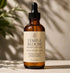 Her•Yang Temple Bloom™ Hairline & Edge Elixir hair oil bottle with dropper, designed to nourish hairlines and edges.