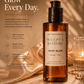 Her•Yang Sculpt x Restore™ Body Glow body oil in a clear bottle with a golden liquid, featuring a sleek, modern design.